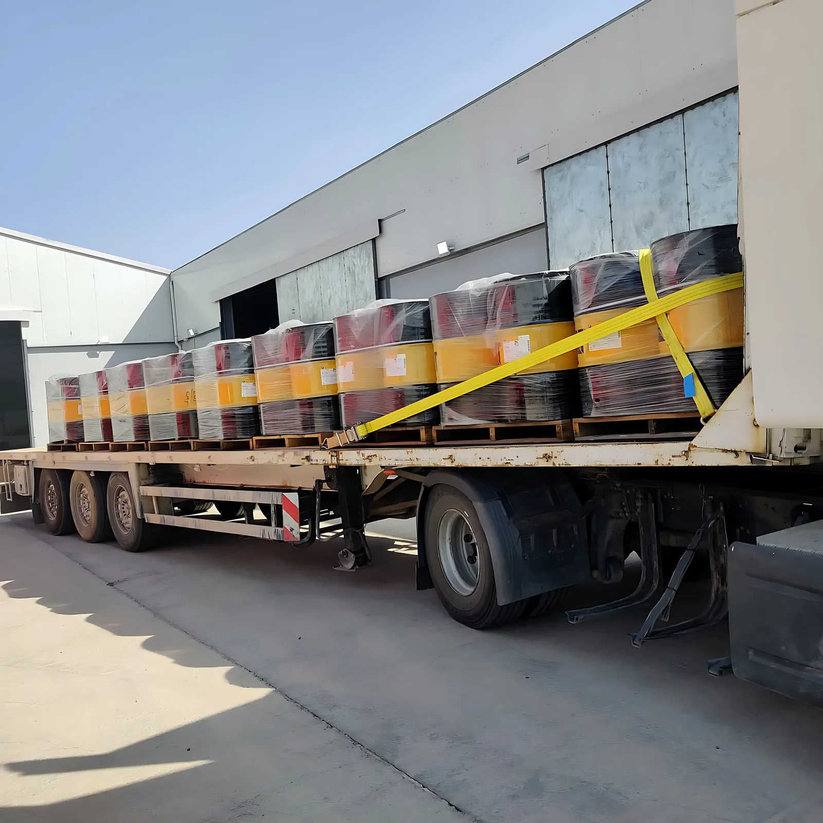 Caterpillar lubricants strapped on a flatbed truck outside the Desert Rock warehouse