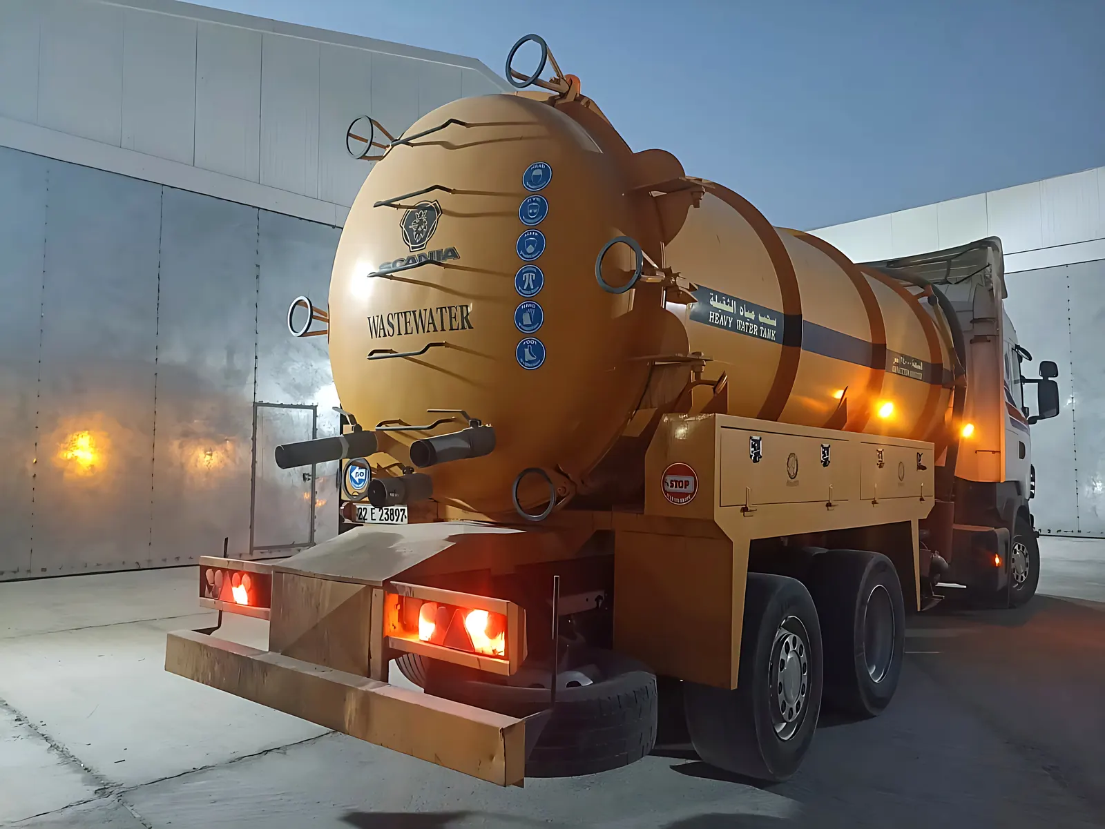 Rear view of a Desert Rock wastewater vacuum truck outside the warehouse